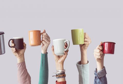 Illustrative picture of hands holding coffee mugs